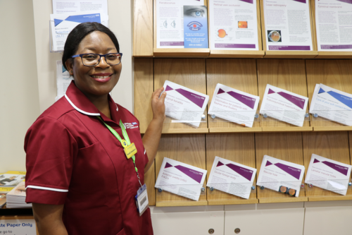 Nurse standing by patient information